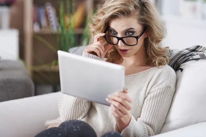 Customer reacting to new eyeglass frames discovered through online virtual try-on platform.