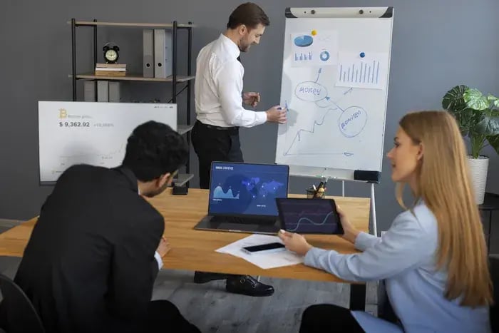 Business team analyzing performance charts for virtual try-on technology in a meeting room.