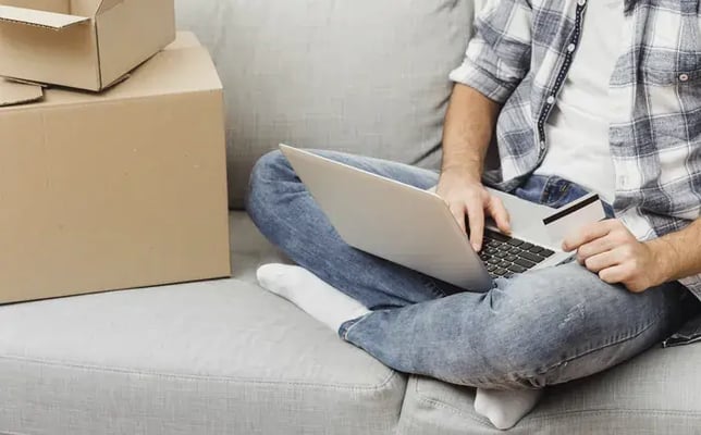 Man comfortably completing a secure, frictionless online eyewear purchase on his laptop.