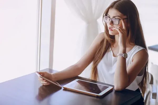 Woman with glasses browsing an eyewear site on her phone.